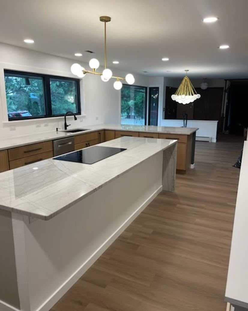 clean modern open concept kitchen with warm custom cabinets